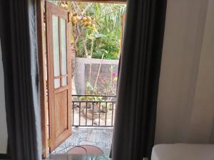 an open door with a view of a garden at Stay Roside Villa Hikkaduwa in Hikkaduwa