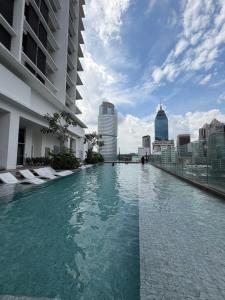 a swimming pool on the roof of a building at Quill Residence Suites KLCC By Sara in Kuala Lumpur