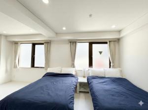 Giường trong phòng chung tại Hotel LEAP