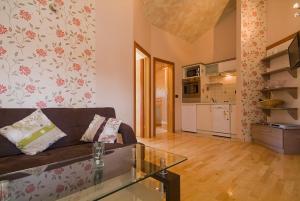 a living room with a couch and a kitchen at Sobe Gora in Posedarje +19 photos
