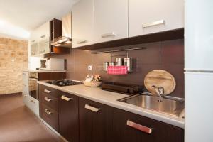 a kitchen with a sink and a counter top at Apartment Welcome in Split