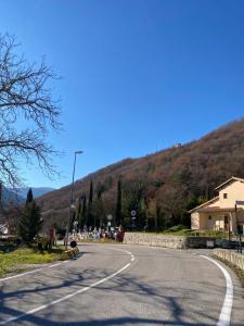 an empty road with a mountain in the background at Casa Rasiglia 3 House Relax in Casenove