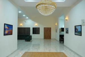 a large lobby with a chandelier and a couch at Salt Water Sanctuary in Diveagar
