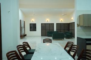 a conference room with a white table and chairs at Salt Water Sanctuary in Diveagar