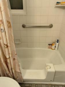 a bathroom with a bath tub with a shower curtain at Casa Castillo 2 in La Puente +4 photos