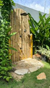 a wooden fence in front of a house at Priima in Ahangama