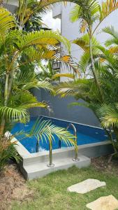 a blue bench sitting next to some palm trees at Priima in Ahangama