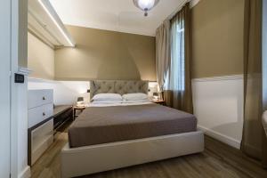 a bedroom with a large bed and a window at Palazzo Bovio - Boutique Apartments in Padova