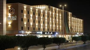 a large building with lights on it at night at Gorash Hotel in Khamis Mushayt