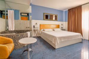 a hotel room with a bed and a couch at Hotel Consentido in Granollers +30 photos