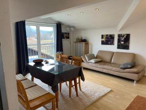 a living room with a table and a couch at Ferienwohnungen Binder in Mauth