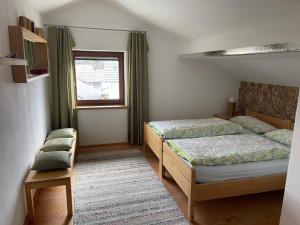 a bedroom with two beds and a window at Ferienwohnungen Binder in Mauth