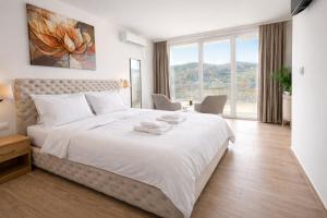 a bedroom with a large bed with a large window at Green panorama Vrdnik in Vrdnik +39 photos