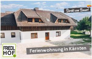 a house with a pitched roof on top of it at FriedlHof Kärnten in Feldkirchen in Kärnten