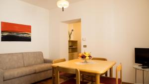 a living room with a table and a couch at Casa Vacanze Boario in Boario Terme