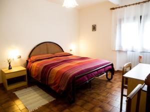 a bedroom with a bed and a table and a window at Casa Vacanze Boario in Boario Terme