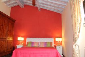 - une chambre dotée d'un mur rouge et d'un lit avec deux lampes dans l'établissement Max Apartments, à Florence