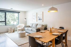 a living room with a table and a couch at Qs Hideaway in Mackenzie Village in Revelstoke