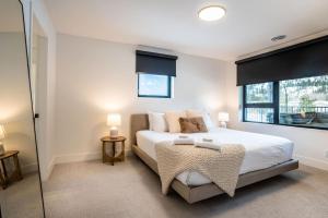 a bedroom with a large bed and a window at Qs Hideaway in Mackenzie Village in Revelstoke