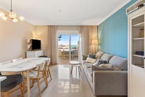a living room with a couch and a table at Topacio A114 in Mijas Costa