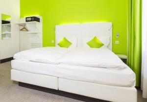 Postel nebo postele na pokoji v ubytování Hotel City Inn Basel