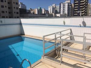 a swimming pool on the roof of a building at Apart Quartier Latin Hotel in Vitória