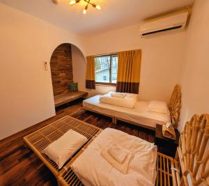 a bedroom with two beds and a window at Kaido Nomad CoLiving in Yuzawa +60 photos