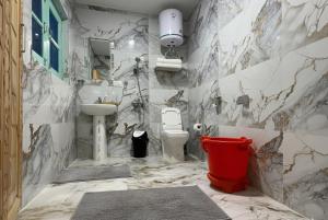 a bathroom with a toilet and a sink at The Routes Pahalgam in Kolur
