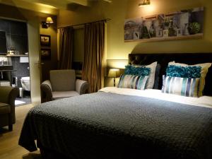 a bedroom with a large bed with blue pillows at Boutique hotel Het Bloemenhof in Dudzele +76 photos