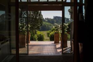 an open door with a view of a garden at AktiVital Hotel in Bad Griesbach +60 photos