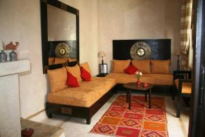 a living room with a couch and a table at Riad Diana in Marrakesh
