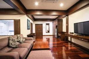 ein Wohnzimmer mit Sofa und Flachbildfernseher in der Unterkunft Wiangkaew Hotel in Ban Fai Kaeo