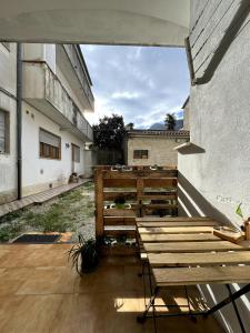 a patio with wooden benches on the side of a building at Bilocale di Charme in Baronissi