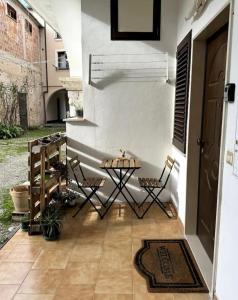 a patio with two chairs and a table next to a door at Bilocale di Charme in Baronissi