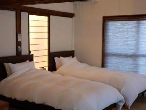 Postel nebo postele na pokoji v ubytování ゲストハウス真鶴の家-Guest House Manazuru House