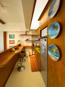 a kitchen with a counter and a refrigerator at Aqua Horizon Beachside Skyline Vista Art Condominium in Dauis