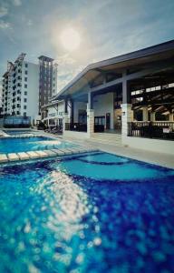 a large swimming pool in front of a building at Aqua Horizon Beachside Skyline Vista Art Condominium in Dauis