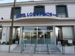 a building with a sign on the front of it at Hotel Los 5 Pinos in Madrid