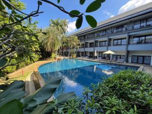 a swimming pool in front of a building at Khao Lak - Loft Suite with 2 king size beds, bathroom with bathtub in Khao Lak +34 photos