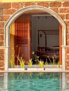 an archway over a swimming pool in a house at Agni Luxury Beach Villa in Olagama +10 photos