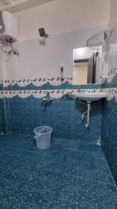 a bathroom with a sink and a mirror at Kutir Stay Aaram in Secunderabad