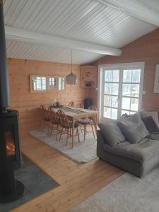 a living room with a table and a couch at Koselig hytte på Beito in Beitostøl
