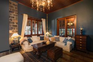 a living room with a couch and a table at Garfield Bungalow by TONIK - 4BR Private Bungalow in Haputale - Mountain Views in Haputale