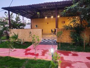 a view of a house with a patio at Khatiya Camp in Mandlā +2 photos