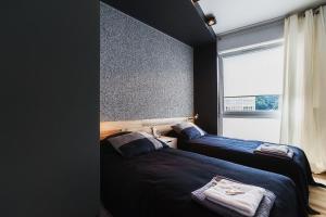 2 Betten in einem Zimmer mit Fenster in der Unterkunft RGB studio in Lublin