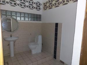 a bathroom with a toilet and a sink at Appartement Baie-Rose SP Nosy-Be in Nosy Be +8 photos