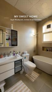 a bathroom with a tub and a toilet and a sink at The Moonridge Retreat in Sinādil +11 photos