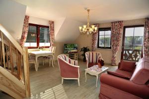 a living room with a couch and a table at Villa Rosamunde in Burg