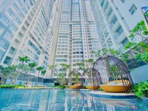 a group of bird cages in front of a tall building at HongHome Happy One Central in Ga Phú Văn