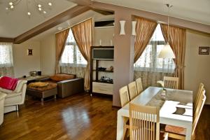 a living room with a table and a dining room at Apartamento Italia in Međugorje